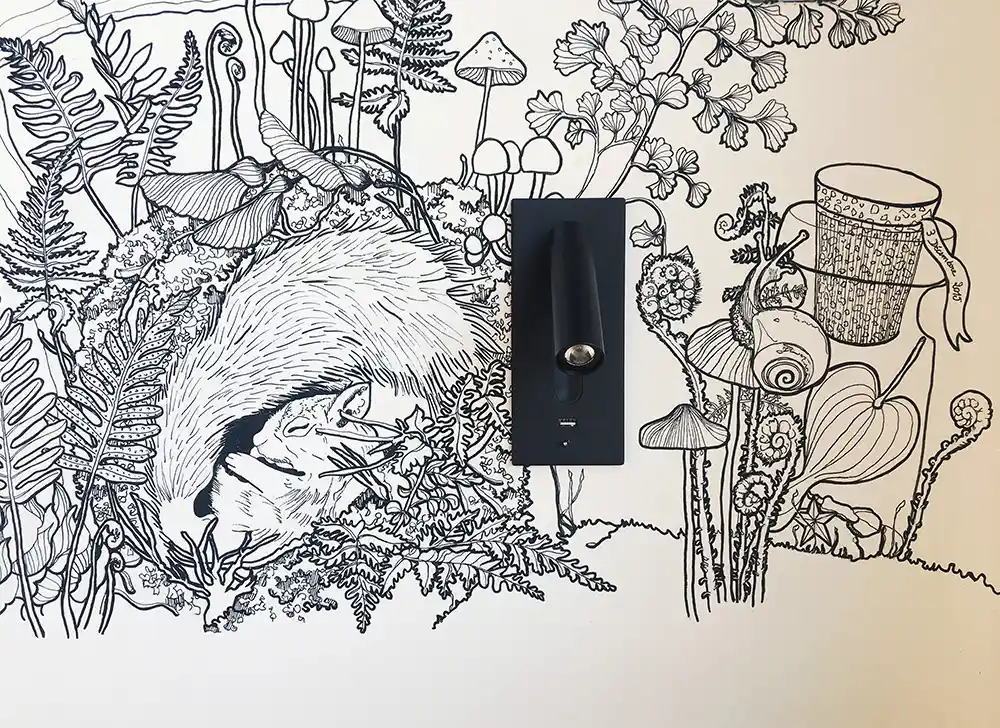 Aménagement intérieur d'une tiny house. Dessin noir et blanc, fresque murale fait main avec applique orientable.